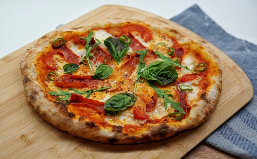 pizza-with-green-leaves-and-red-sauce-xtlpfib7oum